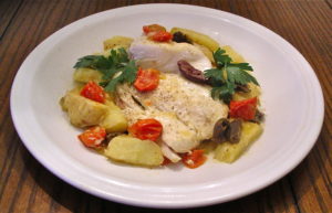 Halibut roasted with cherry tomatoes, potatoes and olives