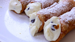 Crispy cannoli shells with a sweet ricotta filling studded with chocolate and candied citrus